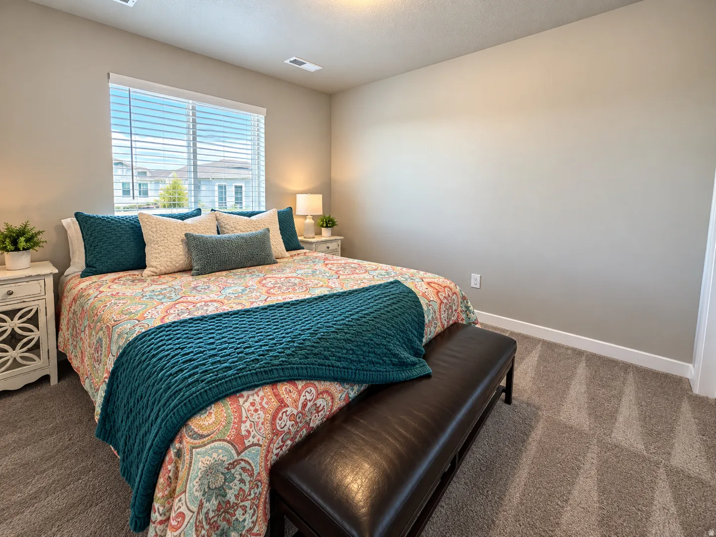 Neutral wall tones, window with horizontal blinds, overhead lighting, and soft carpet flooring