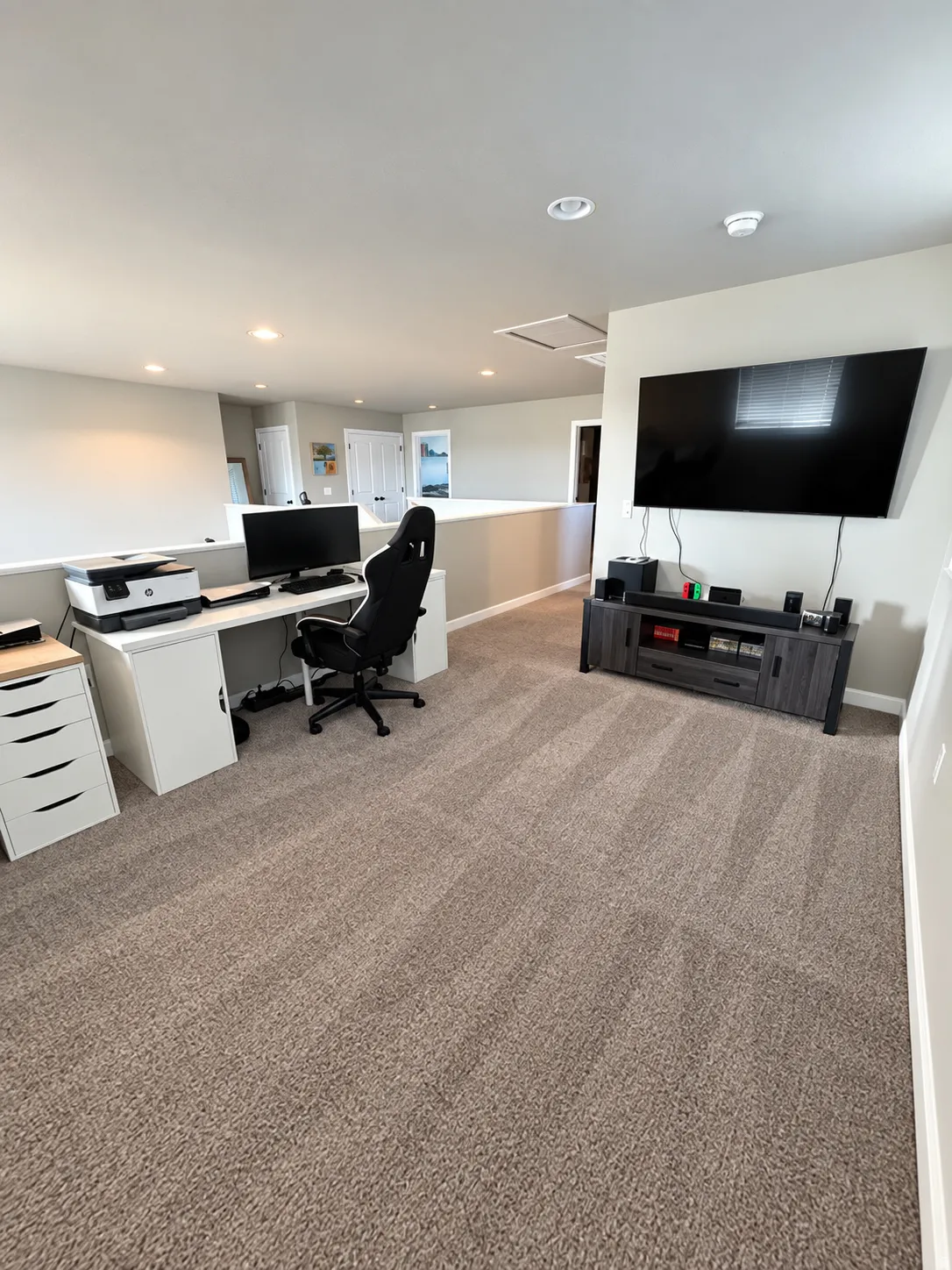 Upper level bonus space featuring recessed lighting, carpeting, and an open railing
