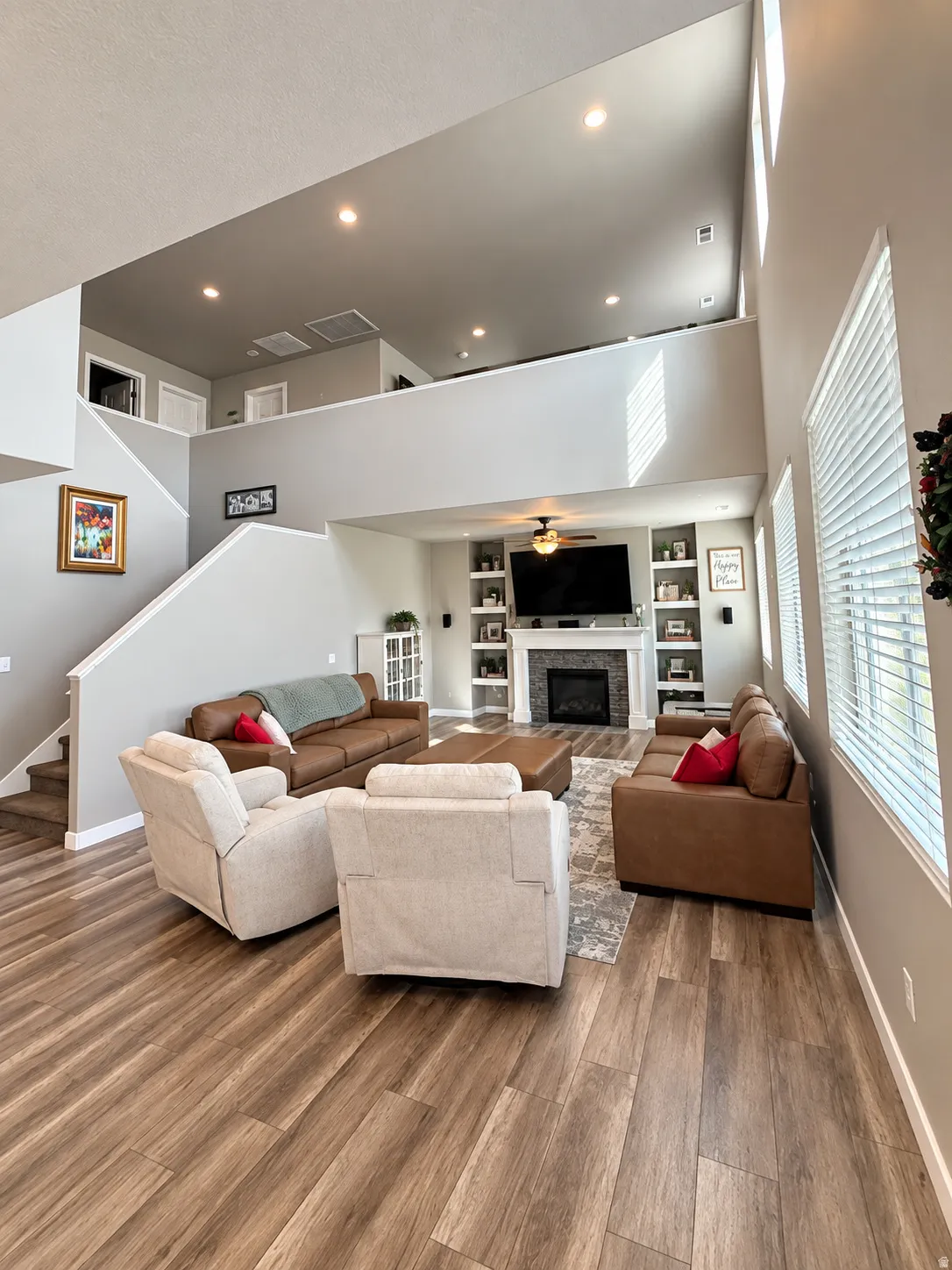 Great room with wood-finish flooring and high ceilings