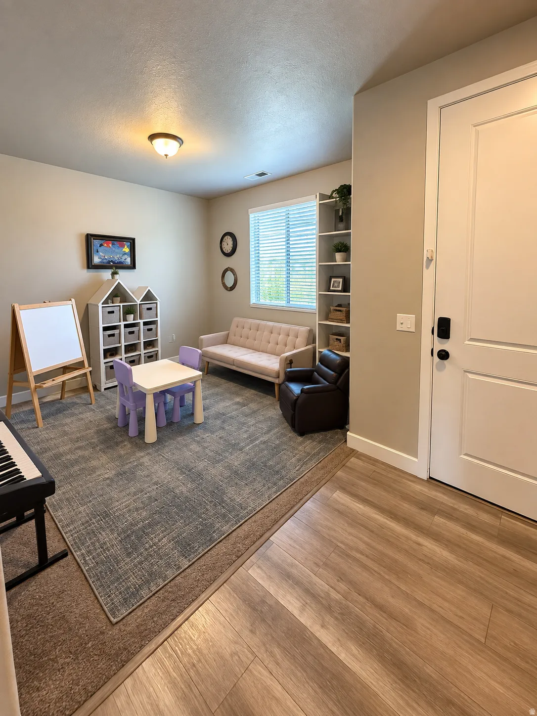 Recessed lighting, built-in shelving, window with blinds, wood-finish flooring, and a paneled interior door