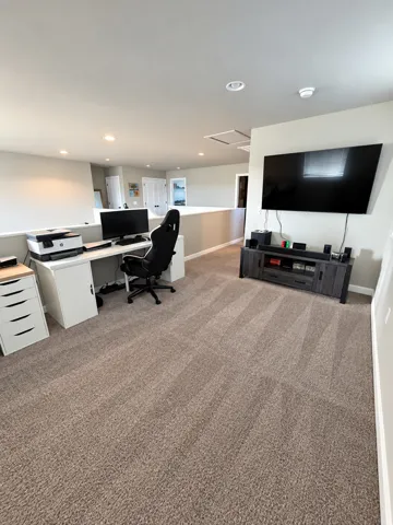Upper level bonus space featuring recessed lighting, carpeting, and an open railing