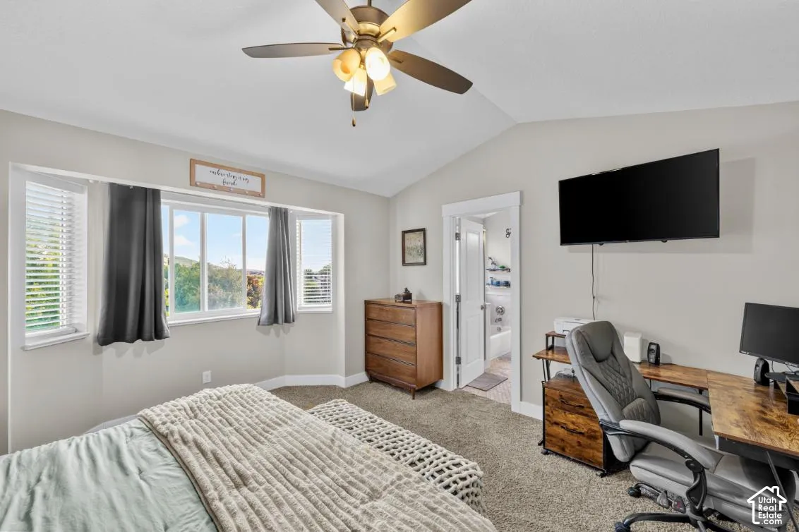 Vaulted ceiling with a ceiling fan, carpeted flooring, and bay window with blinds