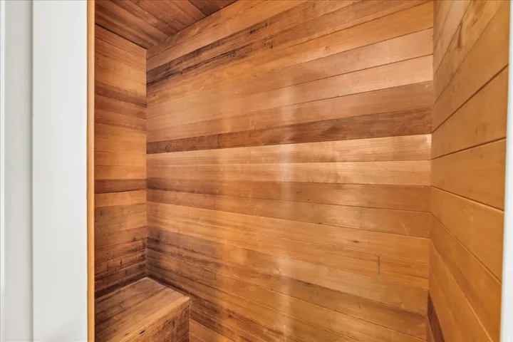 Interior space featuring wood paneling throughout and a built-in wood bench