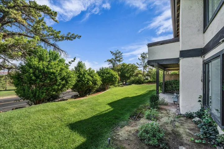 Expansive lawn with mature trees and established landscaping