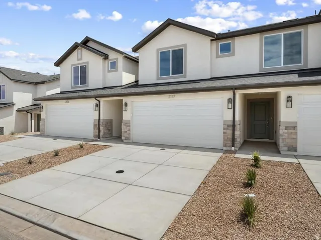Stucco exterior with stone accents and dark trim