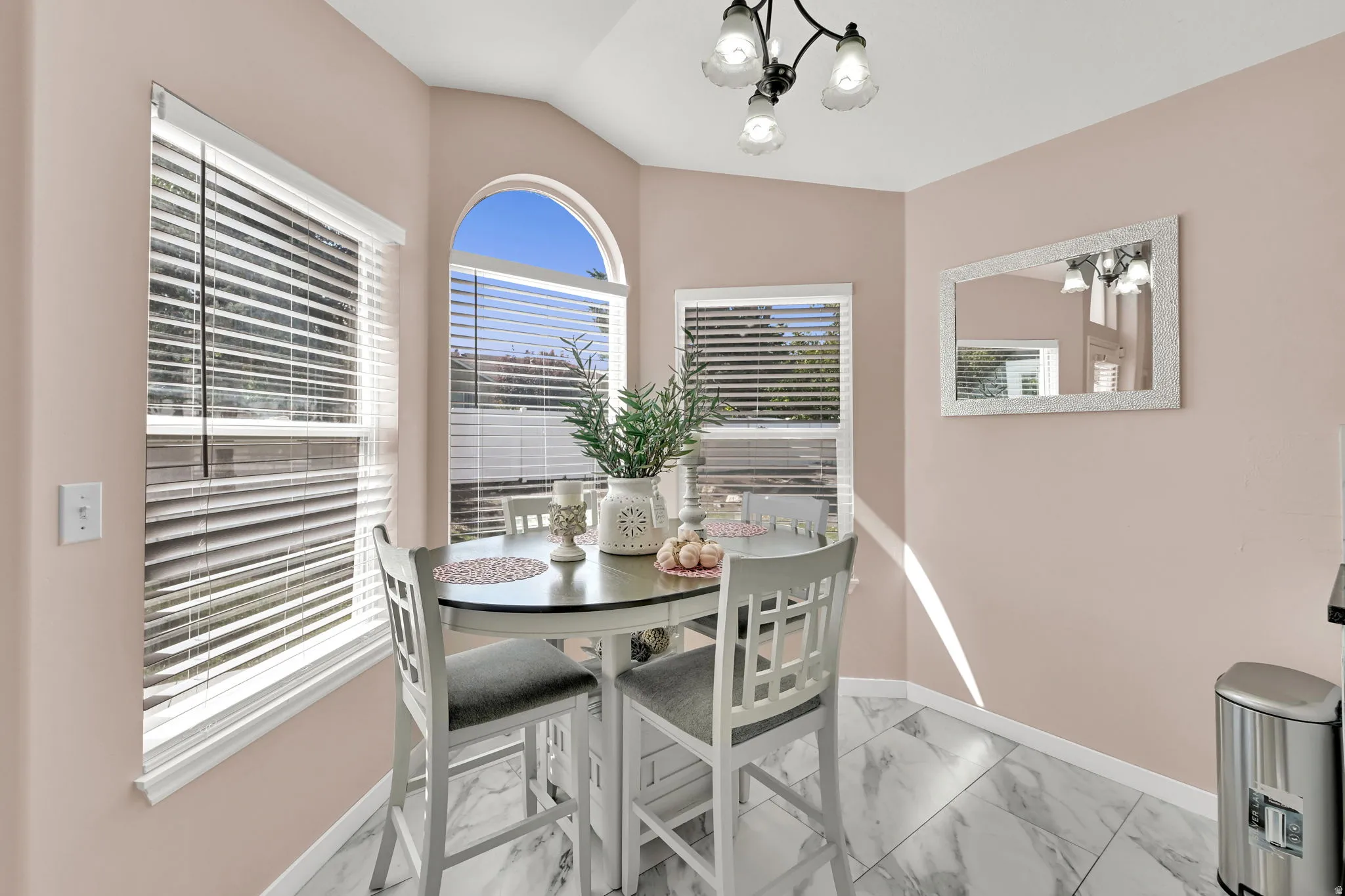 Bay window with an arched transom, recessed lighting, and large format tile flooring