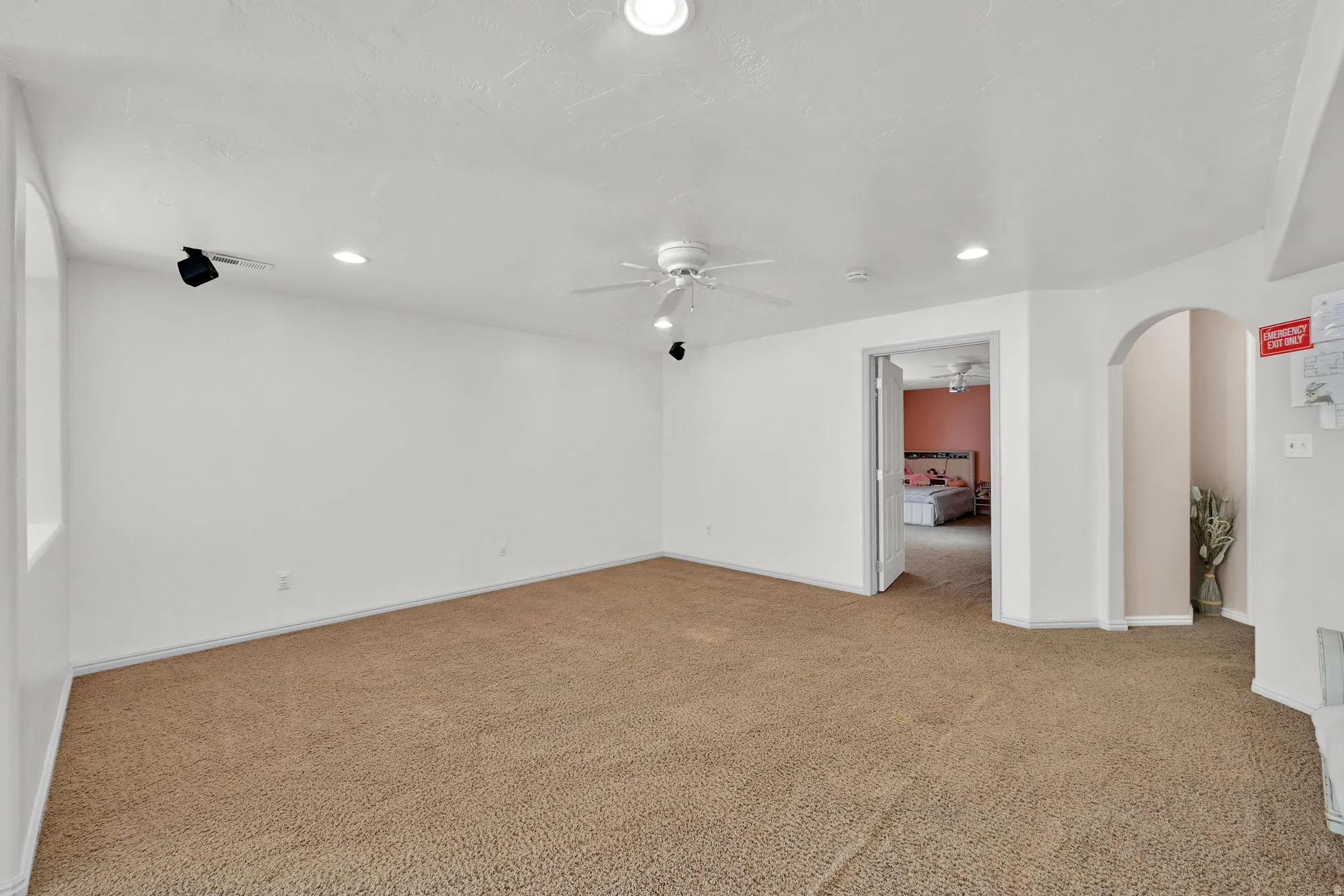 Recessed ceiling lighting, ceiling fan, archway, and wall-mounted track lighting