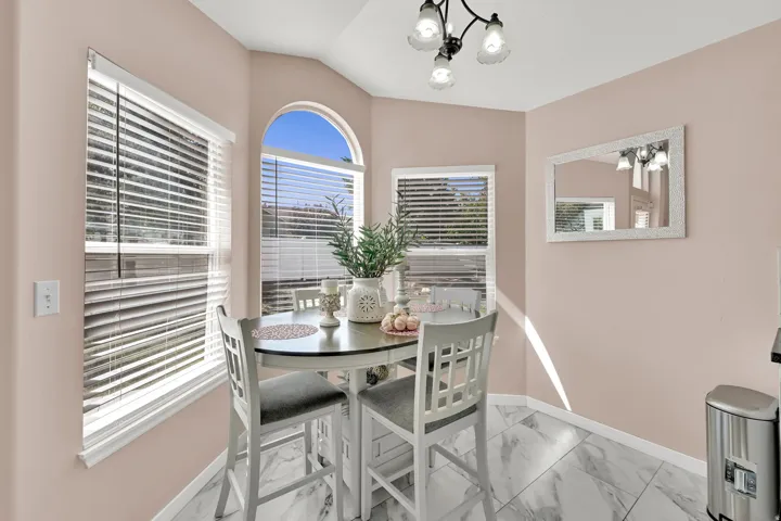 Bay window with an arched transom, recessed lighting, and large format tile flooring