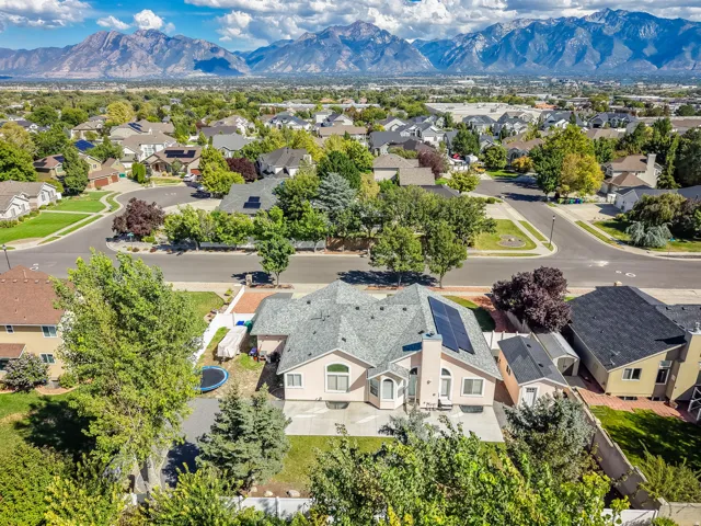 Mountain backdrop, suburban neighborhood, mature trees, residential streets, solar panels
