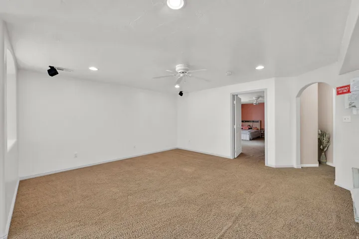 Recessed ceiling lighting, ceiling fan, archway, and wall-mounted track lighting