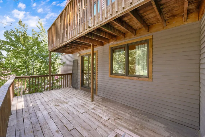 Wood-plank deck with a wood railing and balusters