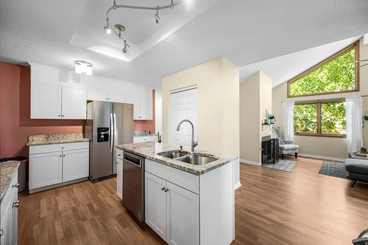 Kitchen featuring white cabinetry, stainless steel appliances, and granite countertops