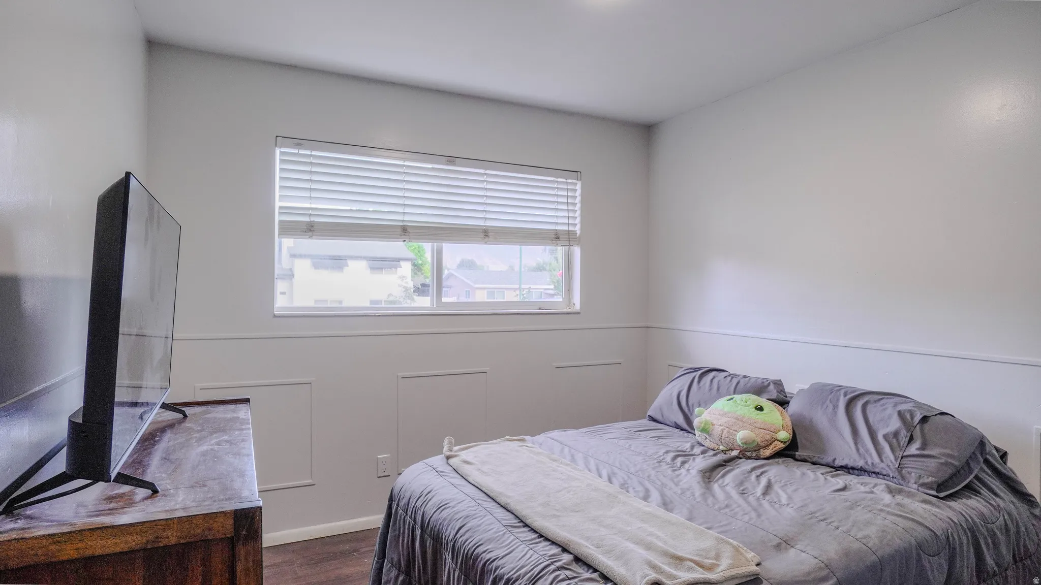 Recessed lighting, wood-finish flooring, and a window with blinds