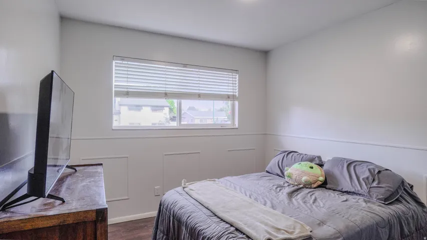 Recessed lighting, wood-finish flooring, and a window with blinds