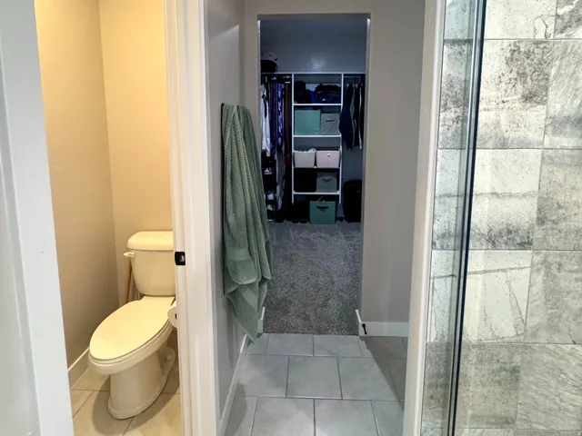 Shower with glass enclosure, large format tile, and hexagon floor tile
