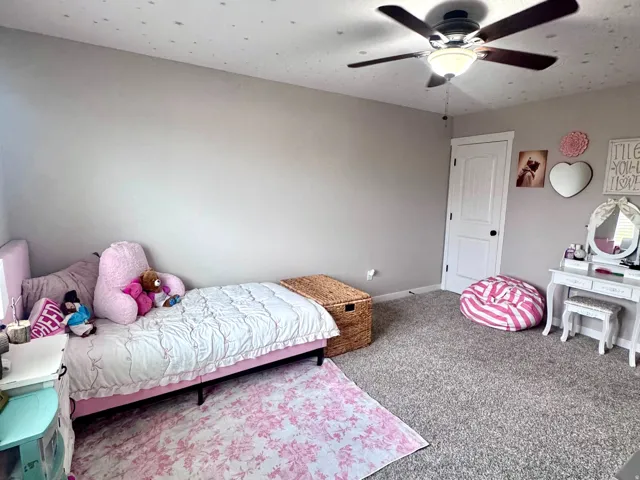Wall-to-wall carpeting with light-colored walls and a ceiling fan with integrated lighting
