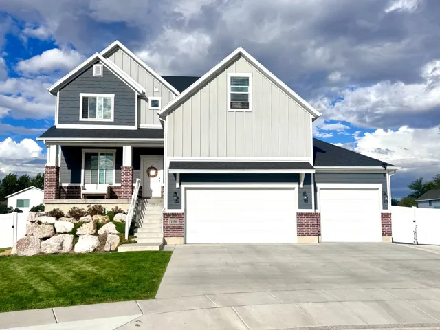 Two-story exterior with a mixed material facade, gabled rooflines, and a covered front porch