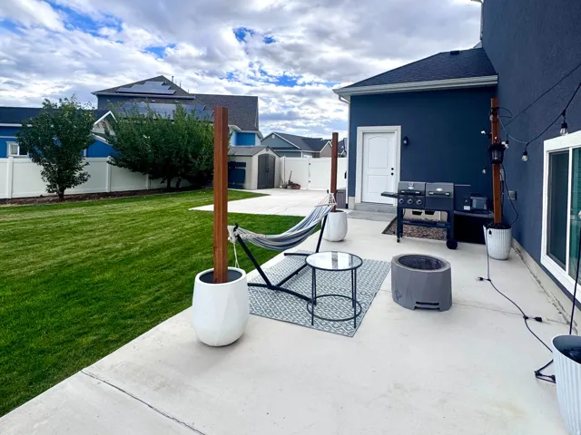 Expansive concrete patio with direct backyard access