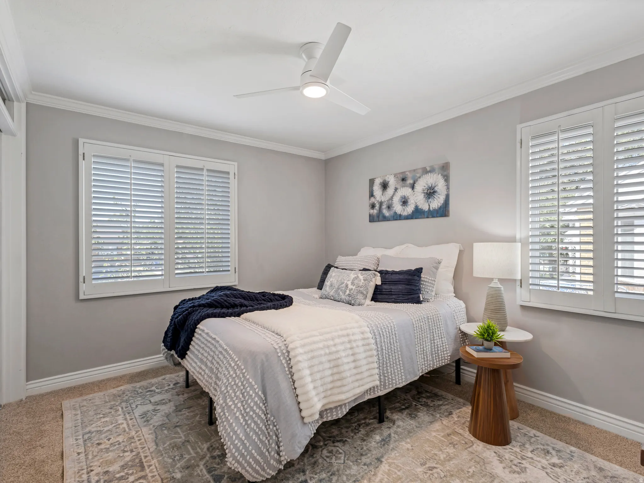 Recessed lighting, crown molding, and two windows with plantation shutters