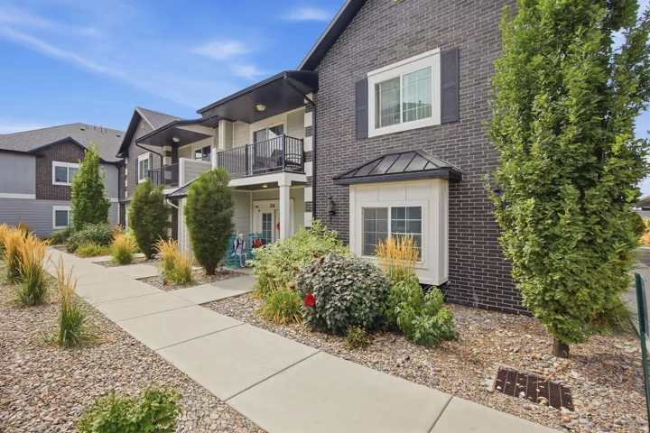 Dark brick exterior with white window trim and black shutters