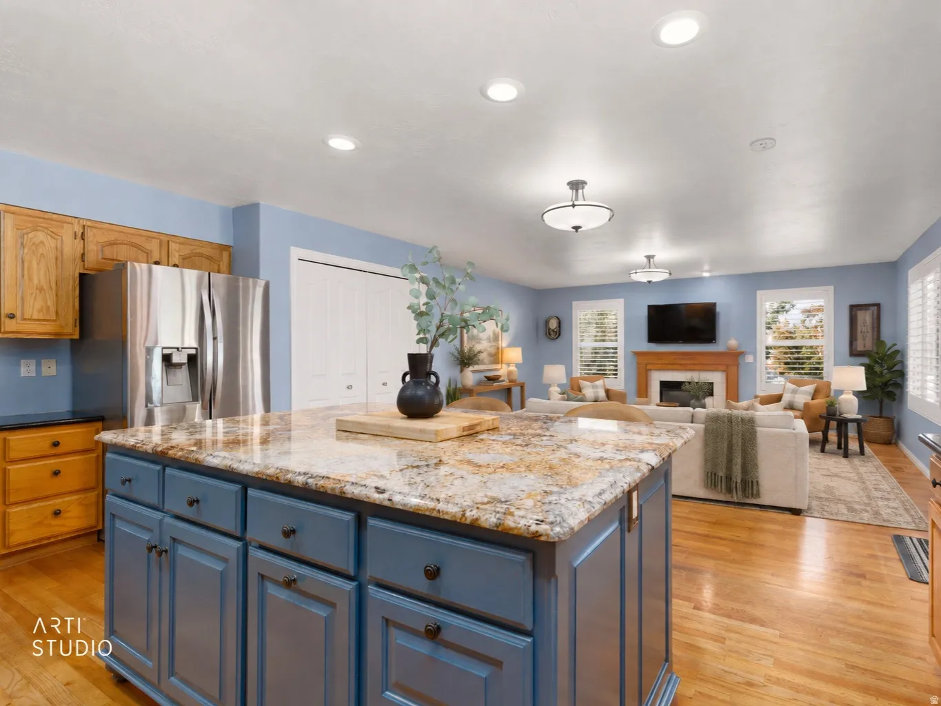 Kitchen island with stone countertop and blue cabinetry