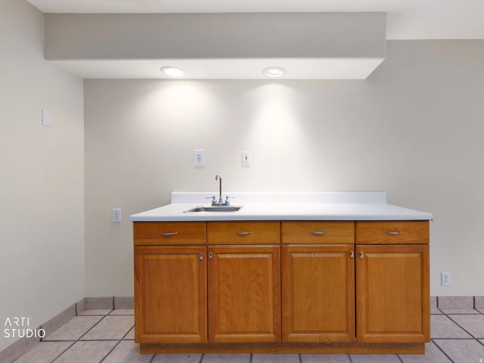 Built-in cabinet with a white countertop and an undermount sink