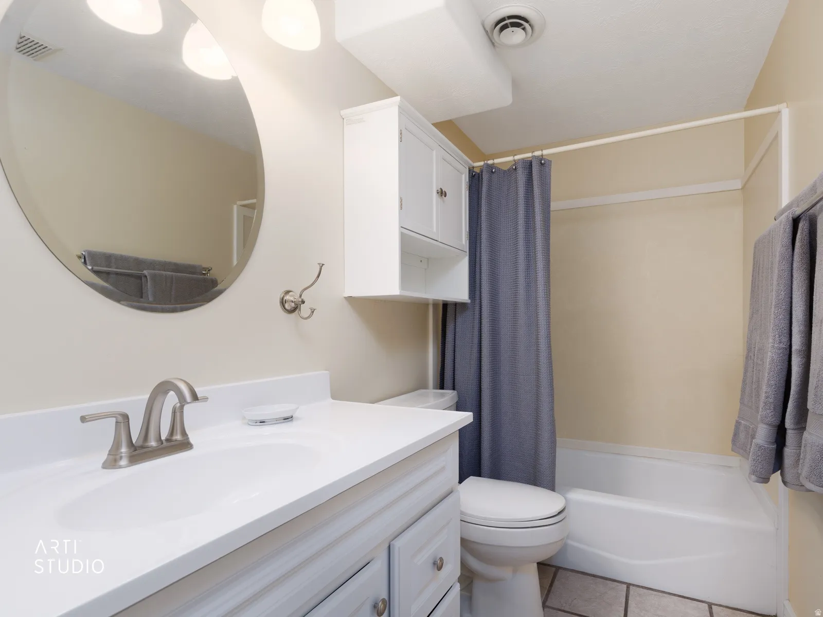 Vanity with white countertop, undermount sink, and brushed nickel faucet