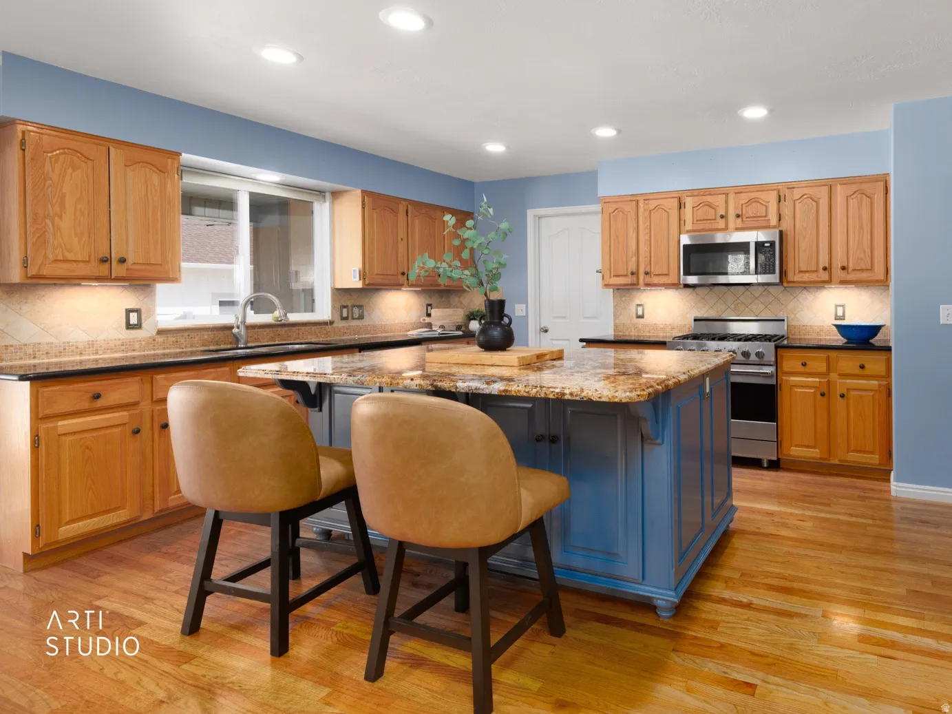 Kitchen featuring wood-finish flooring, recessed lighting, wood cabinetry, stainless steel appliances, and a central island with a stone countertop