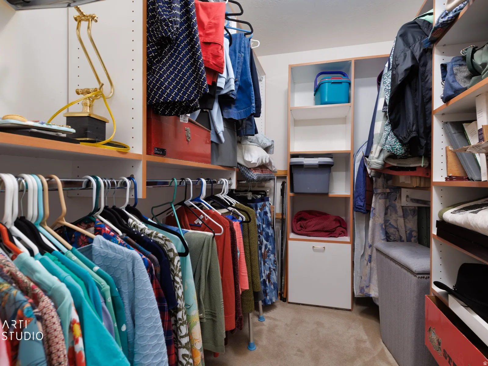 Custom closet system featuring multiple hanging rods, built-in shelving, and integrated drawer storage