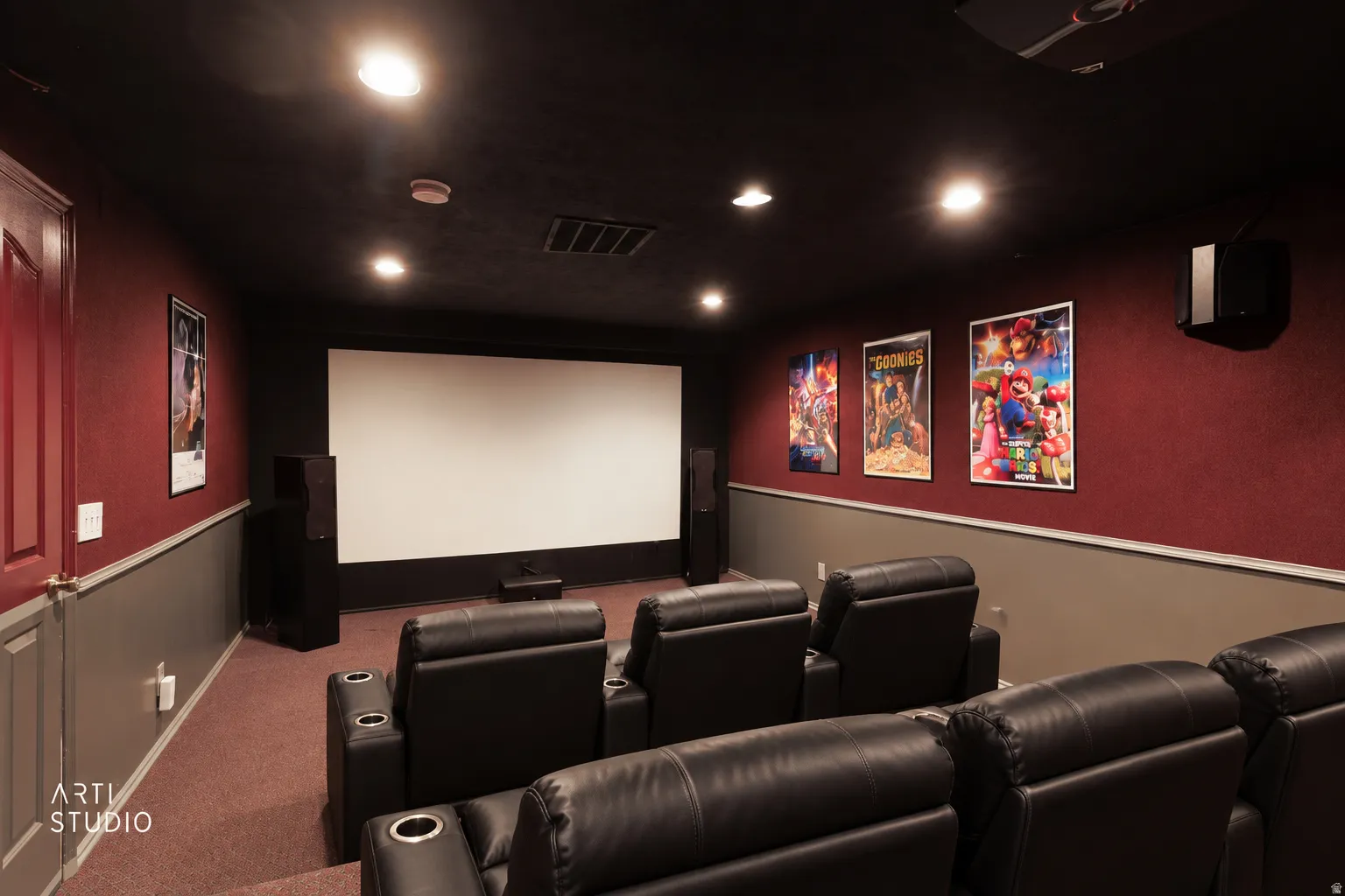 Dedicated home theater featuring a large projection screen, recessed ceiling lights, and wall-mounted speakers with digitally staged furniture.