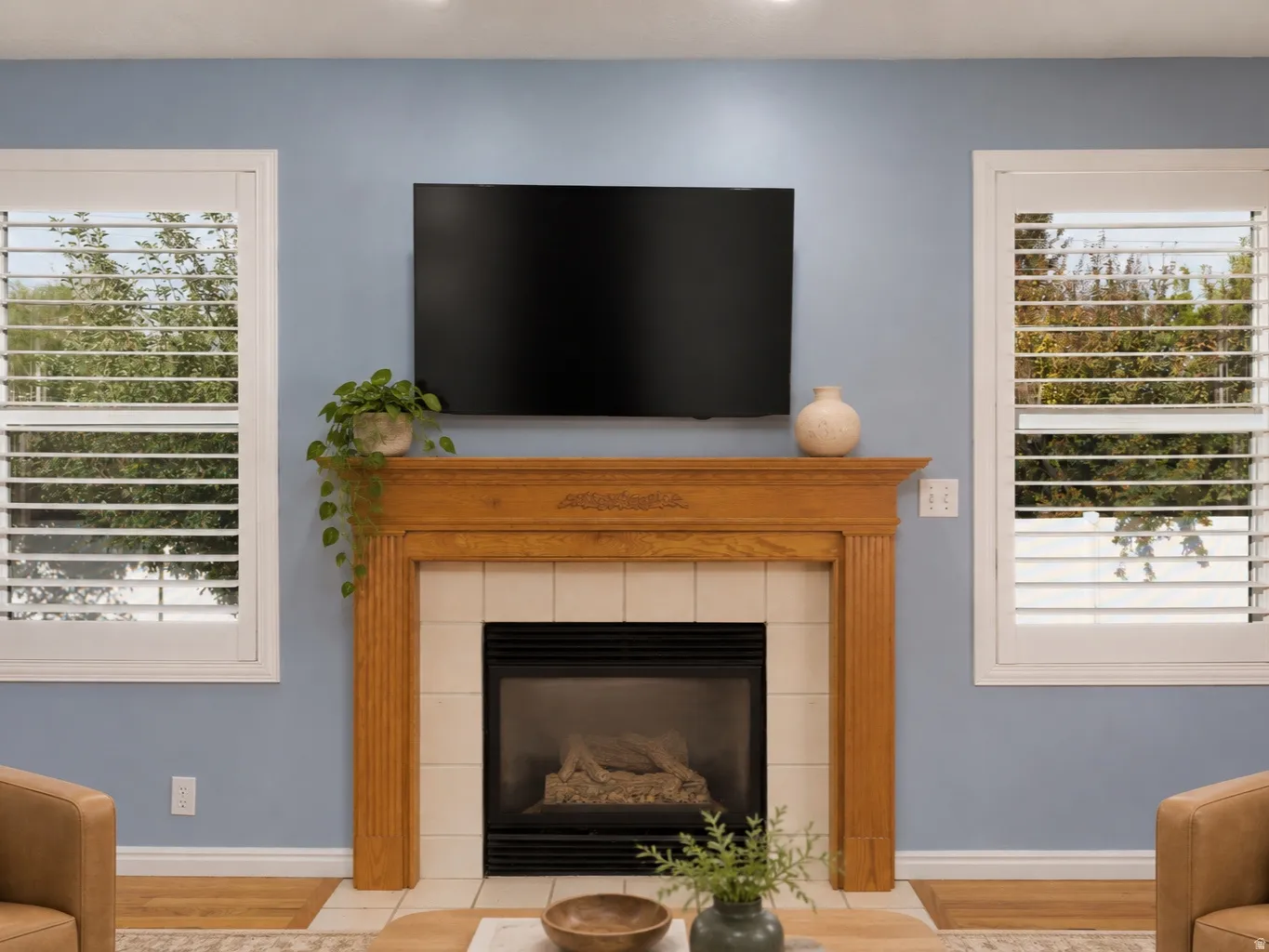 Fireplace with a wood mantel, tile surround, and hearth