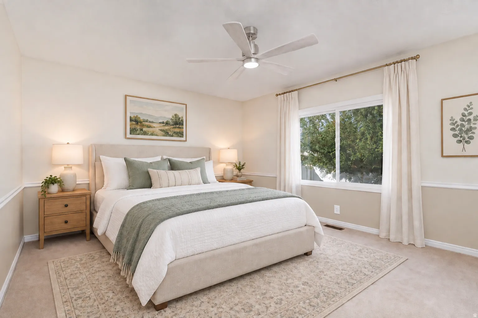 Window with exterior tree scenery, two-tone wall treatment, and ceiling fan with integrated lighting. Main bedroom with digitally staged furniture.
