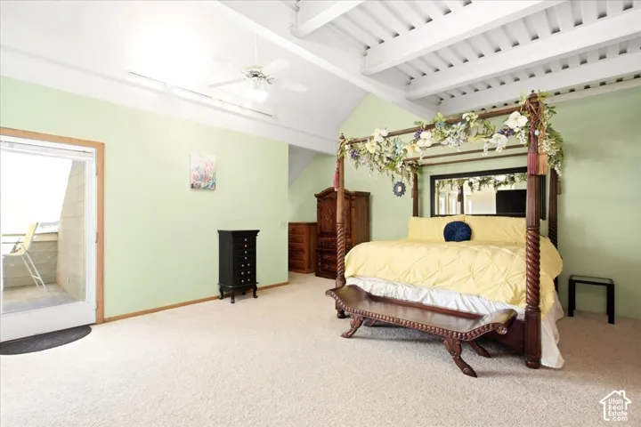 Vaulted ceiling with exposed beams, ceiling fan, carpeted flooring, and a sliding glass door to an exterior balcony
