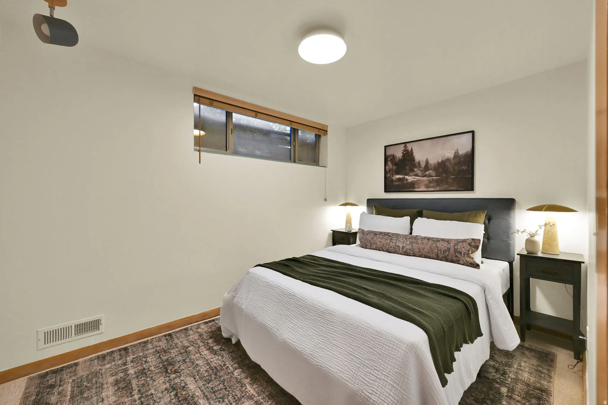 Wall-to-wall wood-finish flooring with a neutral wall color