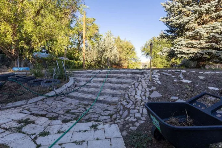 Stone paver steps with integrated stone retaining wall