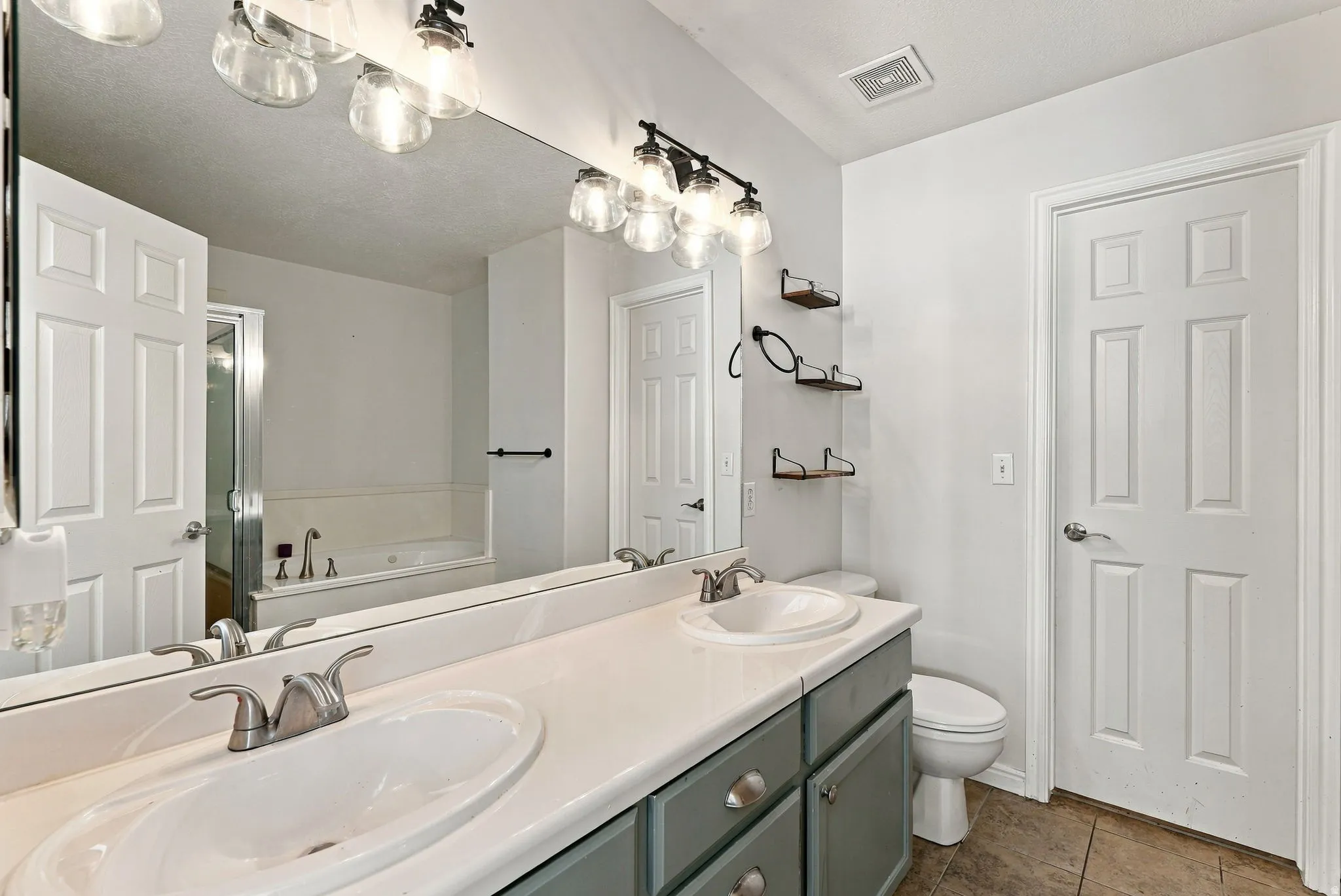 Dual vanity with undermount sinks, brushed nickel fixtures, and a light-colored countertop