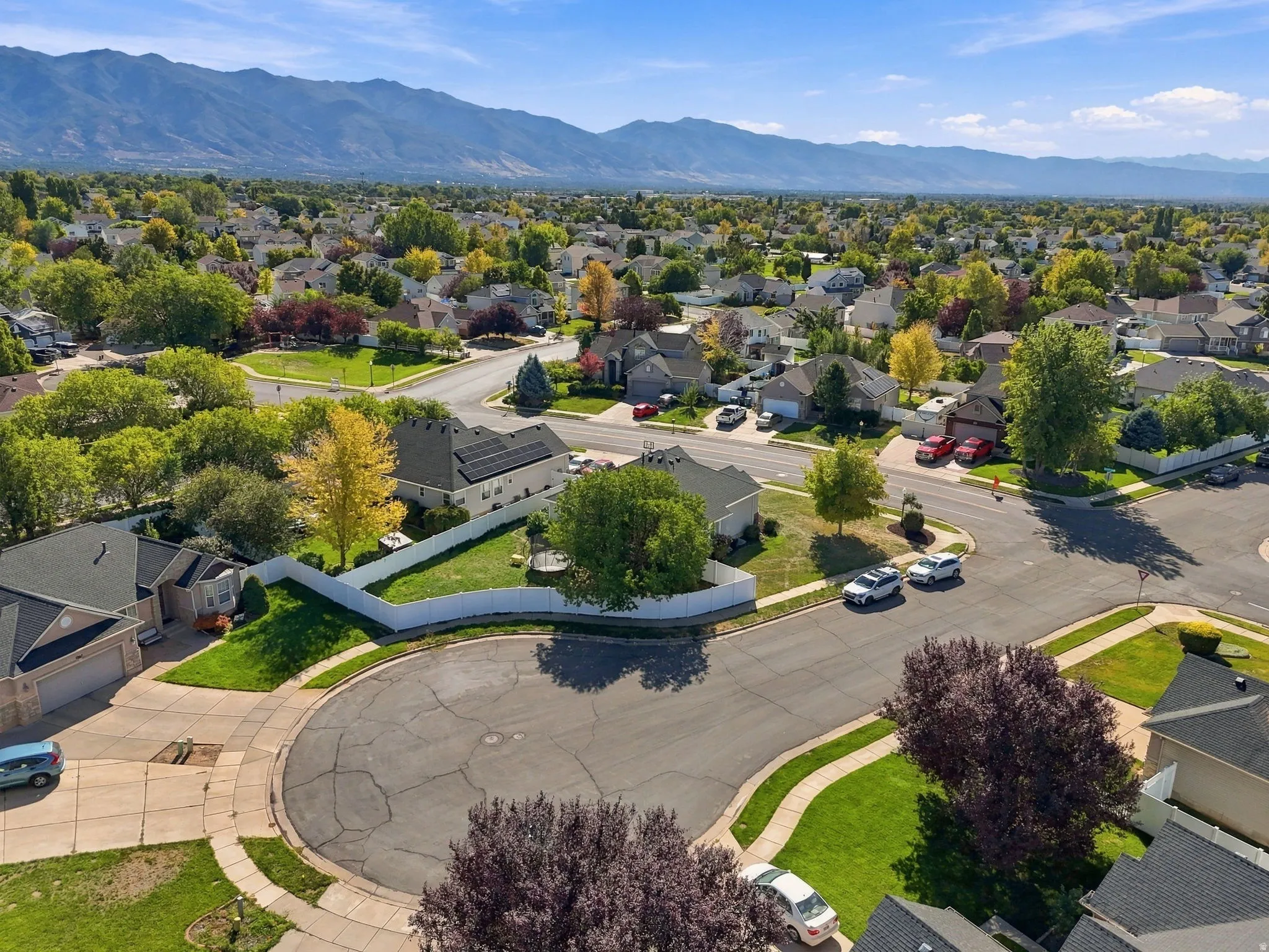 Residential neighborhood with mature landscaping and mountain scenery