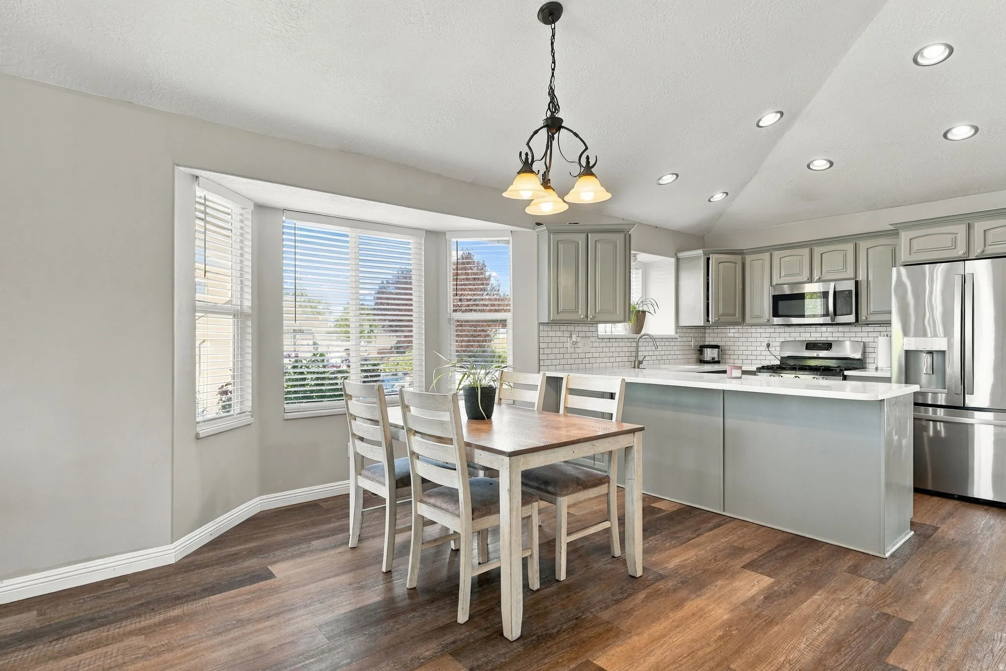Kitchen featuring wood-finish flooring, recessed lighting, and a bay window