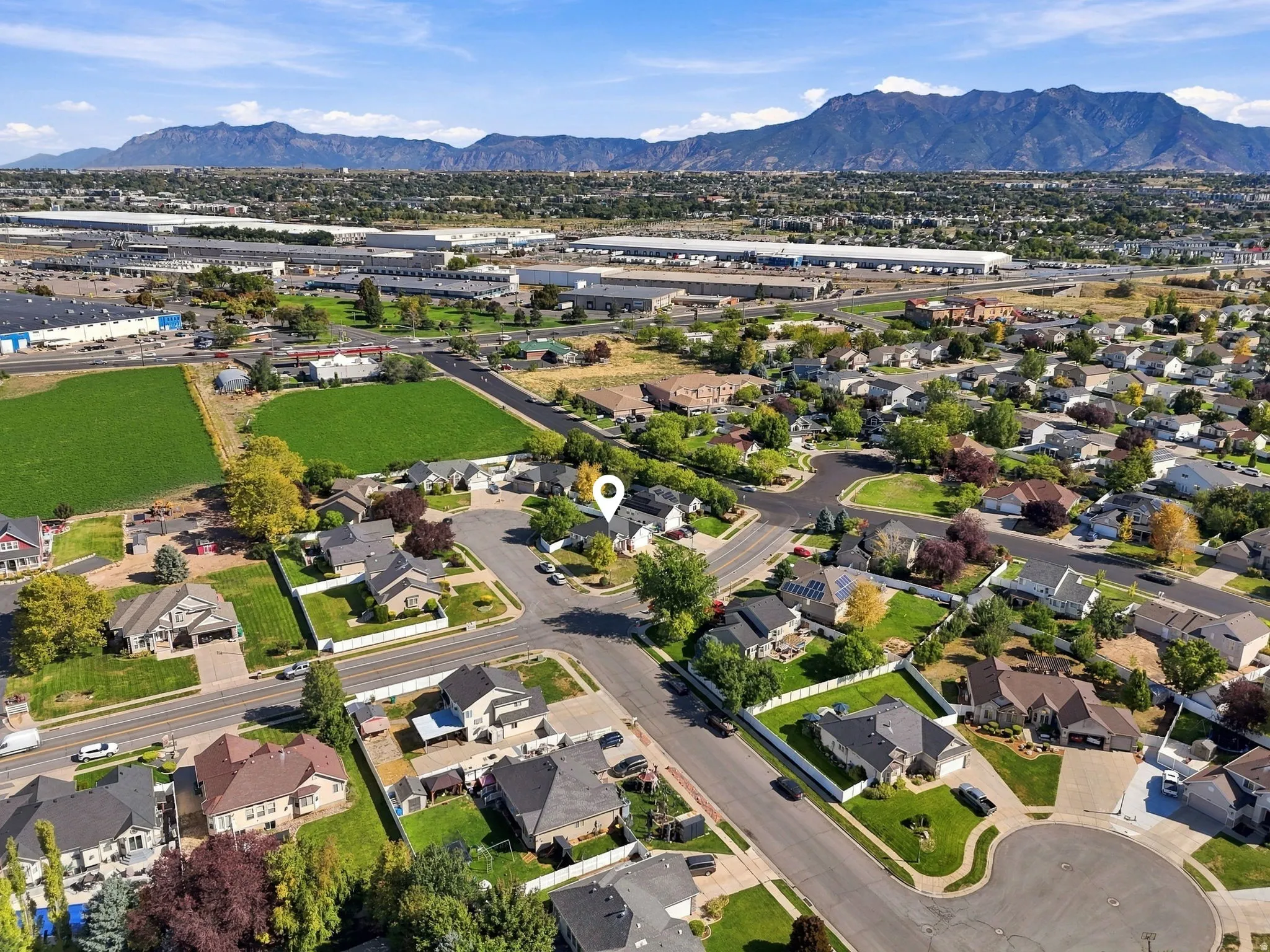 Aerial perspective showcasing residential properties and a mountain backdrop