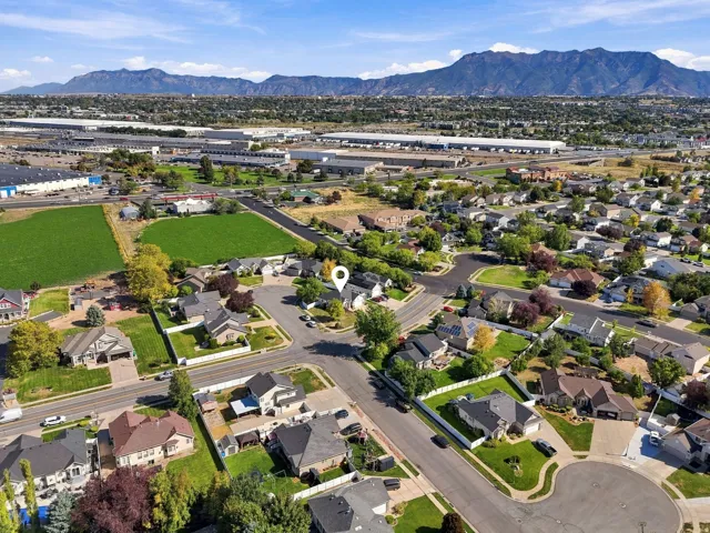 Aerial perspective showcasing residential properties and a mountain backdrop