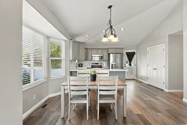 Vaulted ceilings, wood-finish flooring, recessed lighting, shaker-style cabinetry, and stainless steel appliances