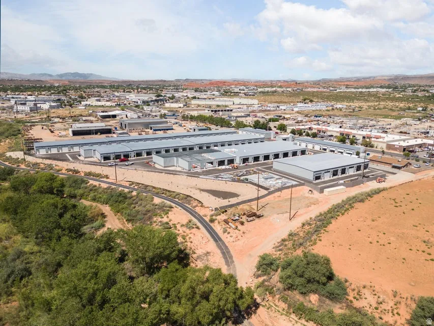 Expansive commercial property featuring multiple industrial buildings with metal siding, loading bay doors, and paved access roads