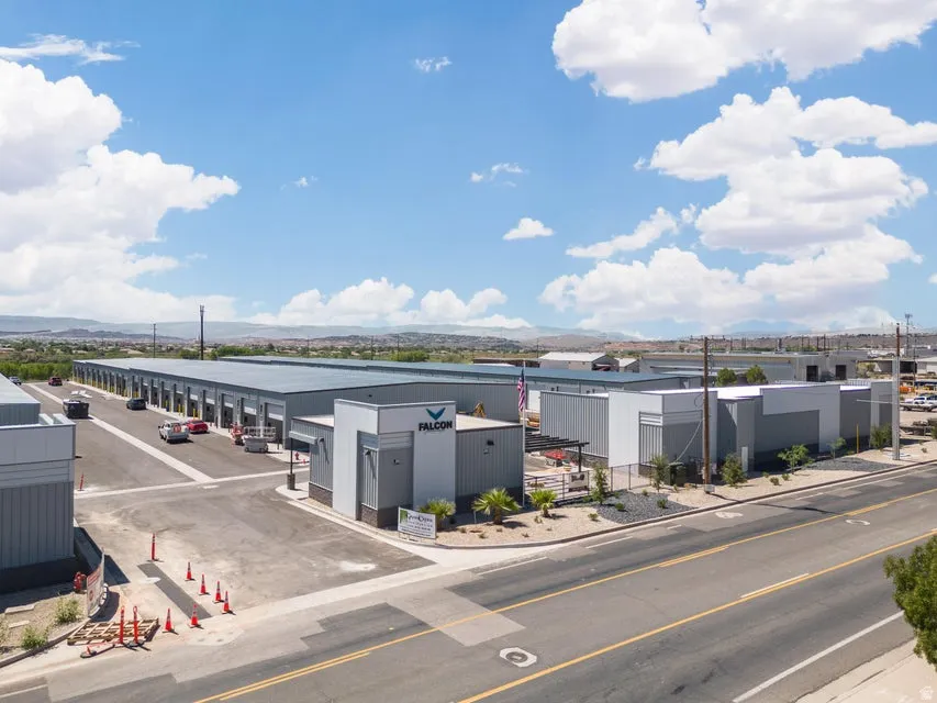 Expansive industrial complex featuring multiple buildings with metal siding and a paved access road