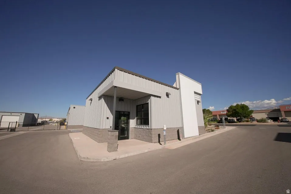 Commercial building with metal siding, a flat roof, and a prominent entry