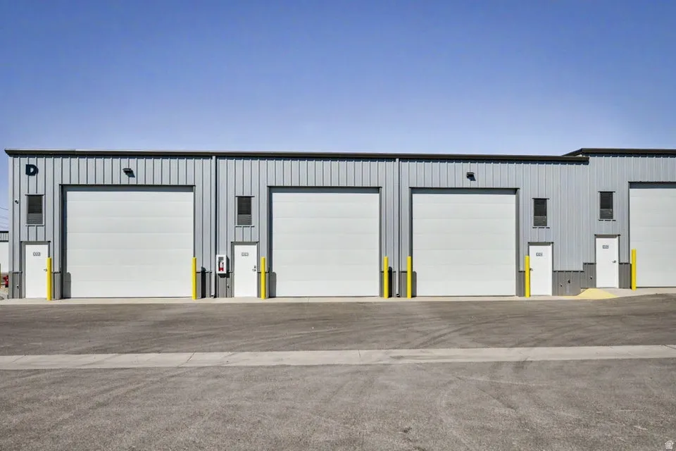 Metal-clad industrial building with multiple large overhead doors