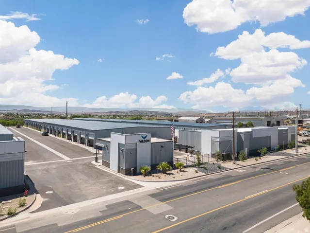 Expansive industrial property featuring multiple buildings, paved roadways, and a prominent front office structure with branded signage