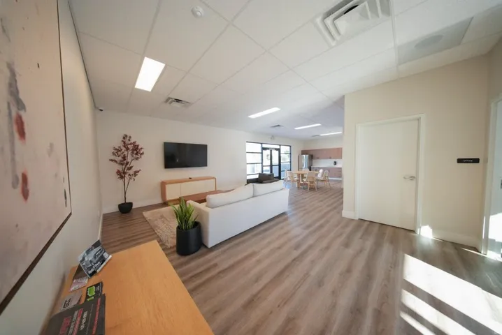 Open-concept common area with wood-finish flooring, recessed lighting, and a white ceiling