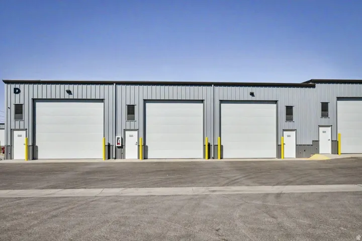 Metal-clad industrial building with multiple large overhead doors