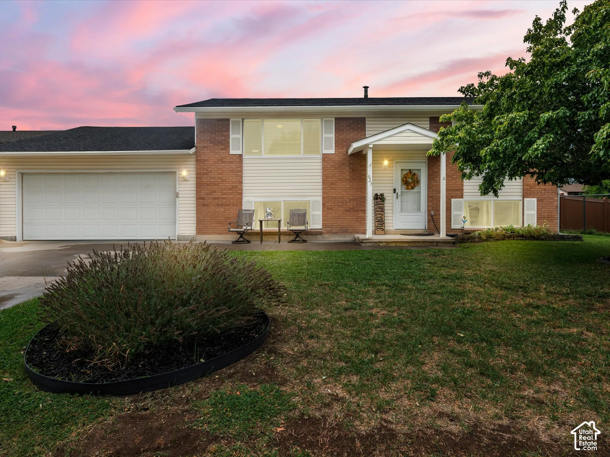 Brick and siding exterior featuring a two-car garage