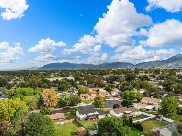 Residential area featuring abundant mature trees and distant mountain ranges